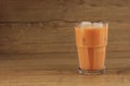 A Glass of Ice Thai Milk Tea on Wooden Table Royalty Free Stock Photo