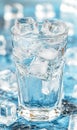 Glass of ice water on blue surface with ice cubes Royalty Free Stock Photo