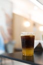 A glass of iced americano black coffee and layer of orange Royalty Free Stock Photo
