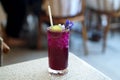 A glass of iced butterfly pea tea with lemonade on blurred background, Relax with Thai herbal drink Royalty Free Stock Photo