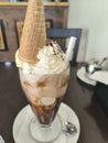 Glass of iced coffee with cream, chocolate sauce and a cone of vanilla ice cream Royalty Free Stock Photo