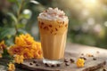 Glass of iced coffee with cream topping on garden