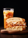 Glass of iced coffee with milk and sandwich with cheese and meat.