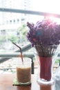 A glass of iced coffee with violet flowers, Lifestyle living