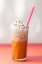 Glass of iced coffee with whipped cream on top with pink plastic Royalty Free Stock Photo