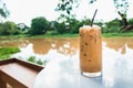 Glass of iced coffee on white table by the riverside Royalty Free Stock Photo