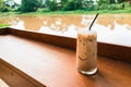 Glass of iced coffee on wooden table Royalty Free Stock Photo