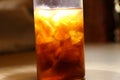 Glass of iced cola in light