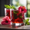 A glass of iced hibiscus mint tea with a hibiscus flower and mint leaf5