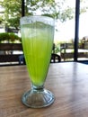 A glass of iced melon lemonade. Fresh orange juice with sweet melon syrup