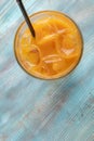 Glass of iced Orange Juice, Top view. Orange Granizado. Refreshing Slushie drink. Iced fruit drink.