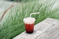 A glass of iced raspberry soda mixed with lemonade juice on blurred background, Tropical mixed mocktail. Royalty Free Stock Photo