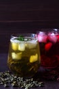 Glass of iced red hibiscus tea and dry flowers on a wooden table. Royalty Free Stock Photo