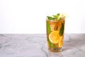 Glass of iced tea with mint and lemon on marble table. Cold drink Royalty Free Stock Photo