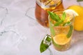 Glass of iced tea with mint and lemon on marble table. Cold drink Royalty Free Stock Photo