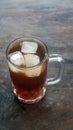 A glass of iced tea on a wooden table. Focus selected Royalty Free Stock Photo