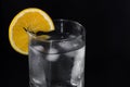 Glass of iced water with an orange slice isolated on a black background Royalty Free Stock Photo