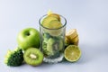 Glass with Ingredients for Fresh Green Smoothie with Kiwi Broccoli Green Apples Babanas and Lime Healthy Detox Blue Background Royalty Free Stock Photo