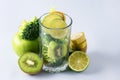 Glass with Ingredients for Healthy Smoothie Banana Kiwi Broccoli Green Apples and Lime Blue Background Detox Drink Royalty Free Stock Photo