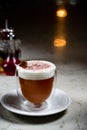 Glass of irish coffee on a table. classic irish coffee saved on a dark bar with a float of heavy cream Royalty Free Stock Photo