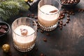 Glass of Irish cream baileys liqueur with ice, roasted coffee beans, cinnamon, Christmas decoration and chocolate on dark wood Royalty Free Stock Photo