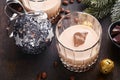 Glass of Irish cream baileys liqueur with ice, roasted coffee beans, cinnamon, Christmas decoration and chocolate on dark wood Royalty Free Stock Photo