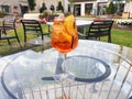 A glass of Italian cocktail Spritz stands on a glass table on the terrace Royalty Free Stock Photo