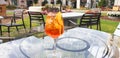 A glass of Italian cocktail Spritz stands on a glass table Royalty Free Stock Photo