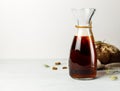 A glass jag with dark rye kvass or beer. On a light wooden background, a basket with rye bread in the background Royalty Free Stock Photo