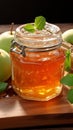 Glass jar Apple jam, two apples, green mint on wooden background