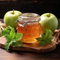 Glass jar Apple jam, two apples, green mint on wooden background