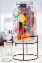 Glass jar beverage dispenser filled with fresh fruits and berries Royalty Free Stock Photo