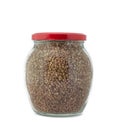 Glass jar with buckwheat closed red cap isolated