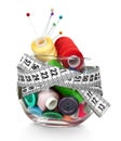 Glass jar, buttons, needle and skeins of thread Royalty Free Stock Photo