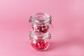 Glass Jar with Candy Sprinkles in Shape of Hearts and Lips on Pink Background Horizontal Royalty Free Stock Photo
