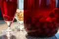 The glass jar of cherry compote, a glass with compote, sweets in a vase, close up Royalty Free Stock Photo