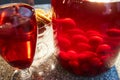 The glass jar of cherry compote, a glass with compote, sweets in a vase, close up Royalty Free Stock Photo