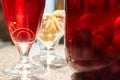 The glass jar of cherry compote, a glass with compote, sweets in a vase, close up Royalty Free Stock Photo