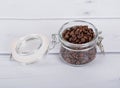 Glass jar with coffee beans Royalty Free Stock Photo