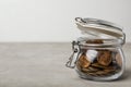 Glass jar with coins on table, space for text Royalty Free Stock Photo