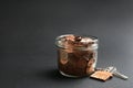 Glass jar with coins and house key on black background. Royalty Free Stock Photo