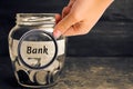 Glass jar with coins and the inscription `Bank`. Deposits, savings and loans. Additional capitalization of banks. Financed public Royalty Free Stock Photo