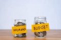 Glass jar with coins and an inscription budget, insurance Royalty Free Stock Photo