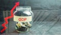 Glass jar with coins and the inscription ` GDP ` and up arrow. Business, economic, finance, salary, crisis. Economic growth concep Royalty Free Stock Photo