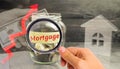 Glass jar with coins and the inscription ` Mortgage ` and up arrow. The increase in interest rates on mortgages. Mortgage lending