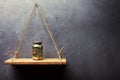 Glass jar with coins on the old wood shelf Royalty Free Stock Photo