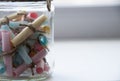 Glass jar with colored notes with blur and toning. Royalty Free Stock Photo