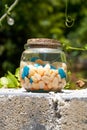 A glass jar with colored stones Royalty Free Stock Photo
