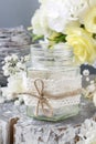 Glass jar decorated with lace and string, white pumpkins