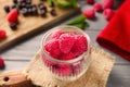 Glass jar with delicious fresh raspberries on wooden table Royalty Free Stock Photo